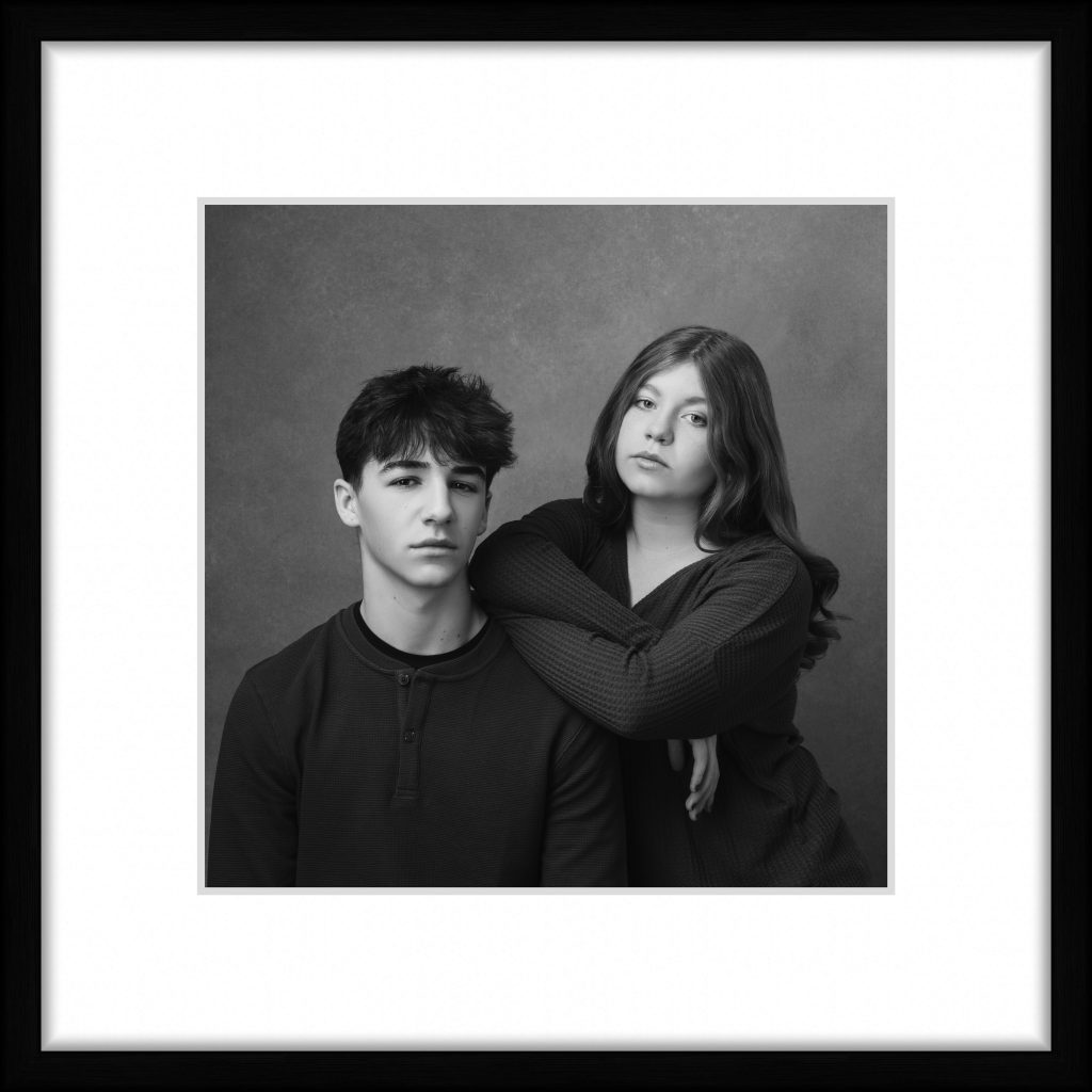 Framed black and white photo of teenage siblings