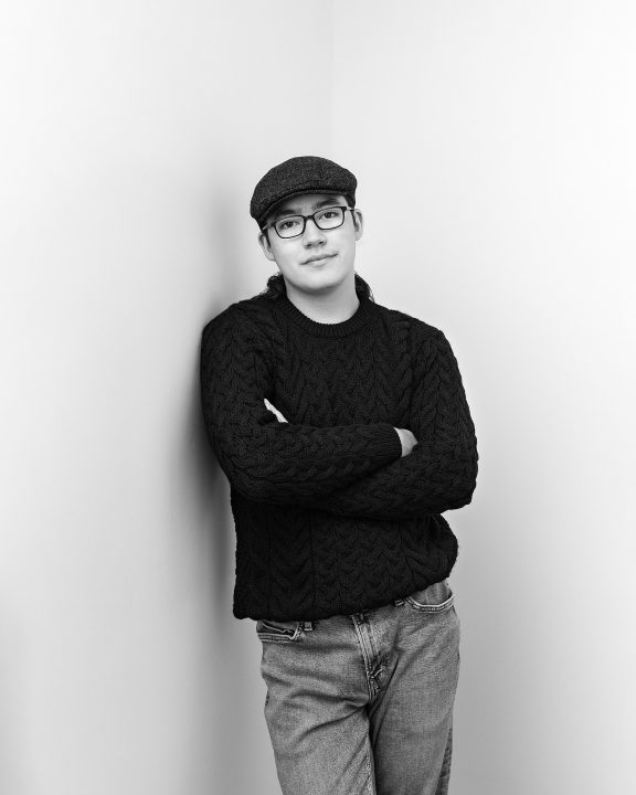 portraits to celebrate 19 - black and white studio photo of David leaning against a wall