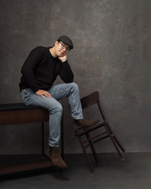 Portraits to celebrate 19 - David sitting on a desk